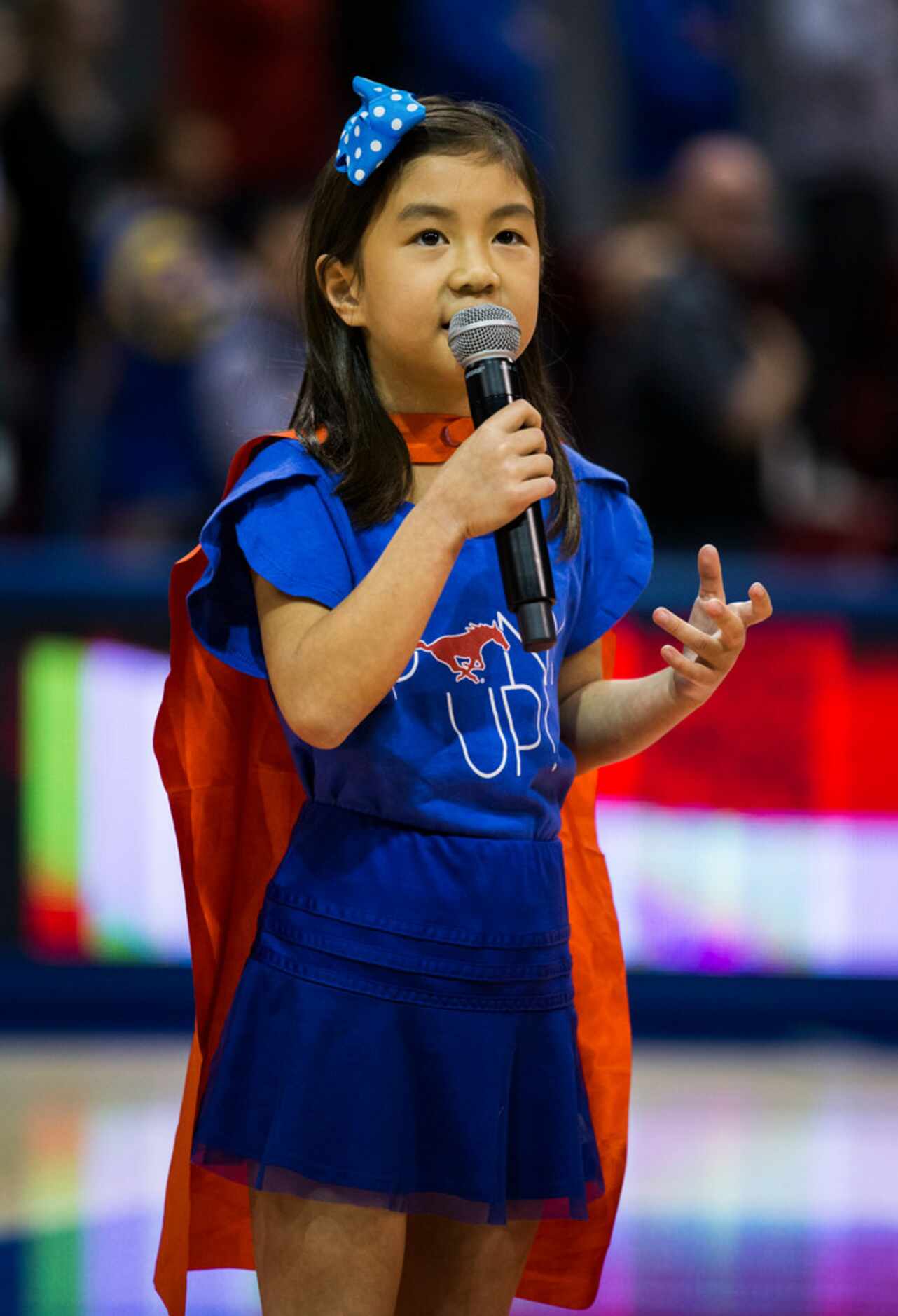 Lila Tran sings the national anthem before a basketball game between SMU and University of...