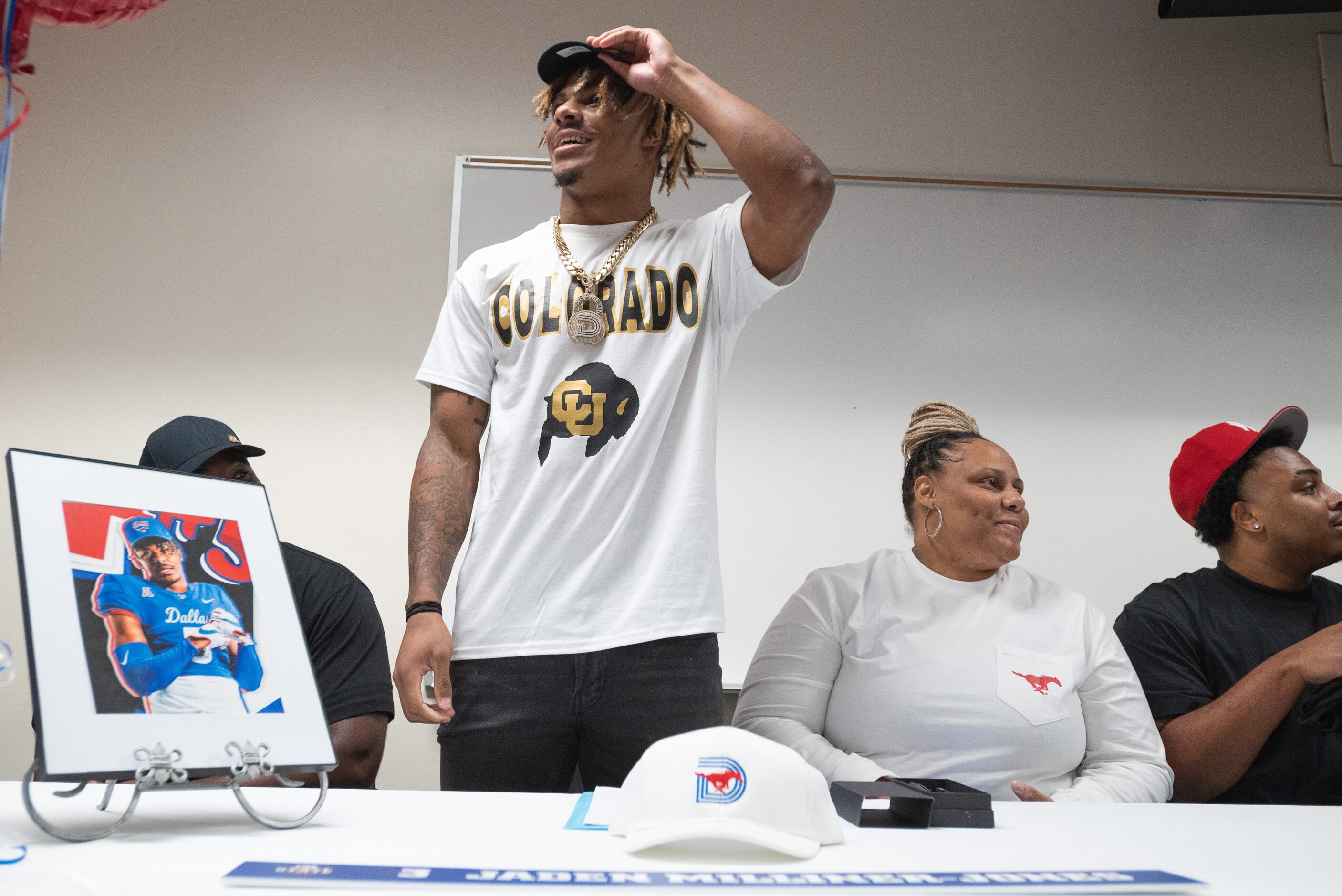 DeSoto high school football player Jaden Milliner-Jones shows off his Colorado merchandise...