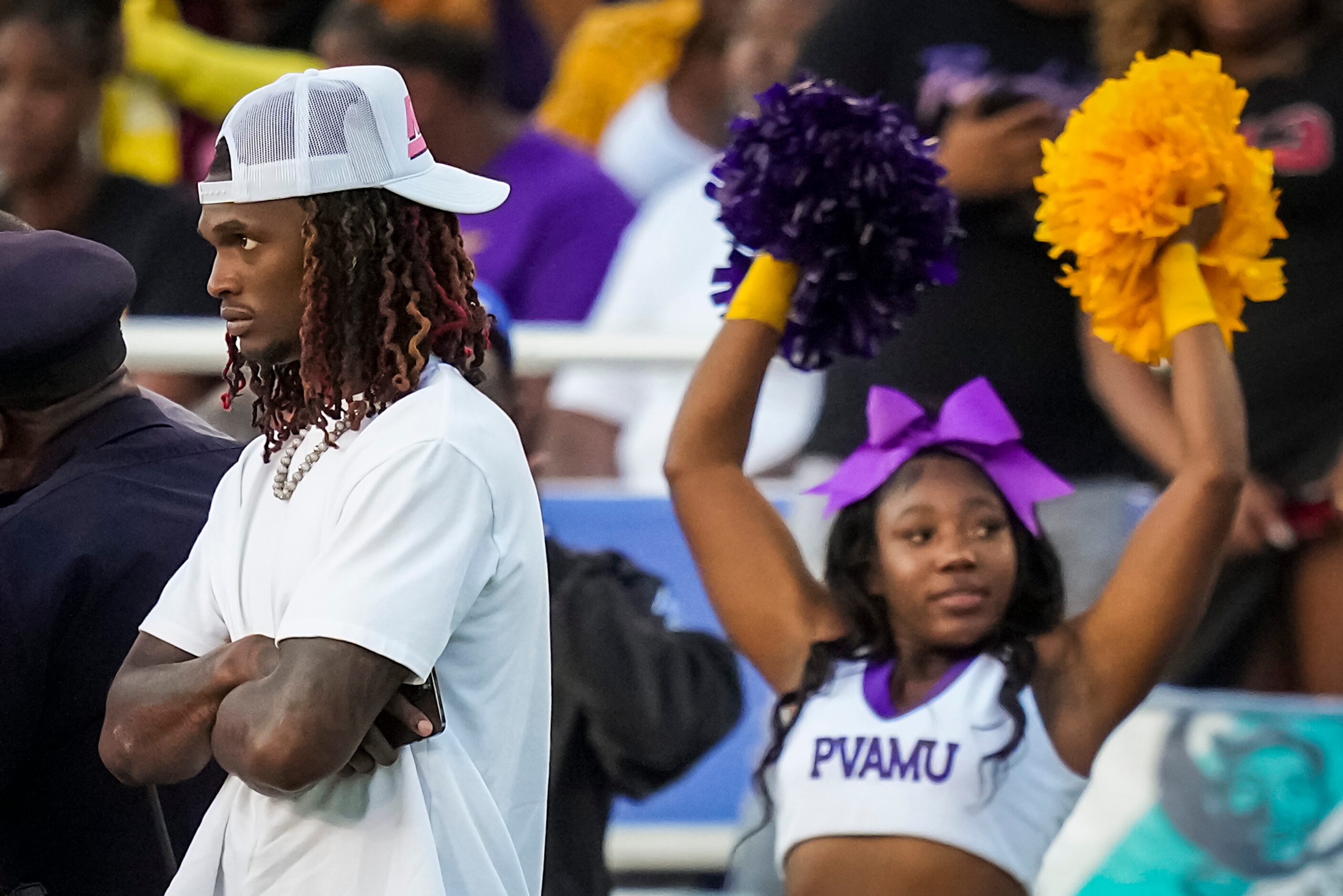 Dallas Cowboys wide receiver CeeDee Lamb (left) watches from the Prairie View sidelines...