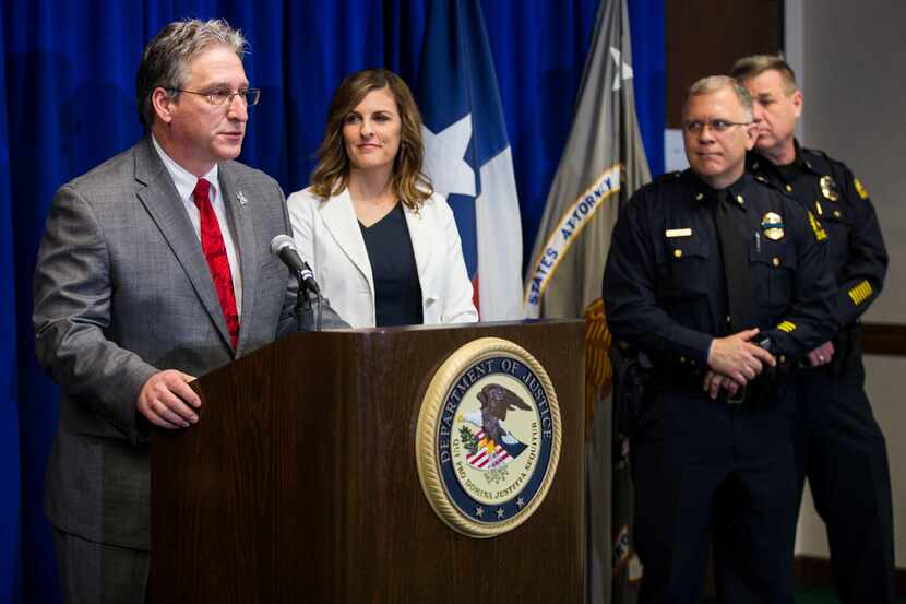 Texas Anti-Gang Center Administrator Todd Reichert, left, speaks at a press conference where...