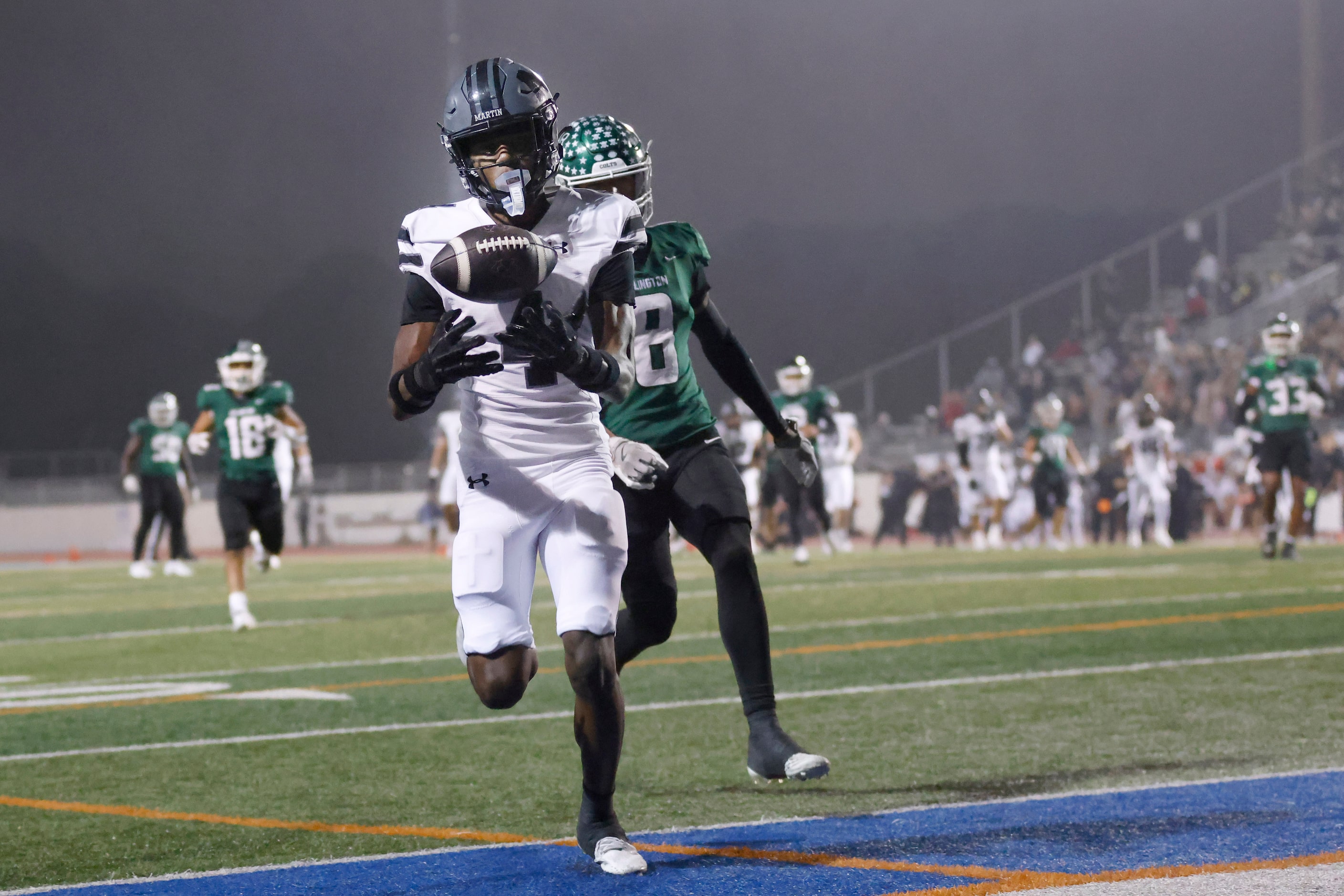 Arlington Martin wide receiver Brody Williams (4) pulls in a long, second quarter touchdown...