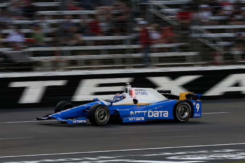 Scott Dixon (9) races during the Rainguard Water Sealers 600 race at Texas Motor Speedway in...