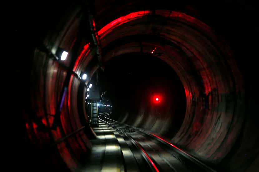 A red light signals the approach of a DART train in a tunnel 80 feet beneath the the...