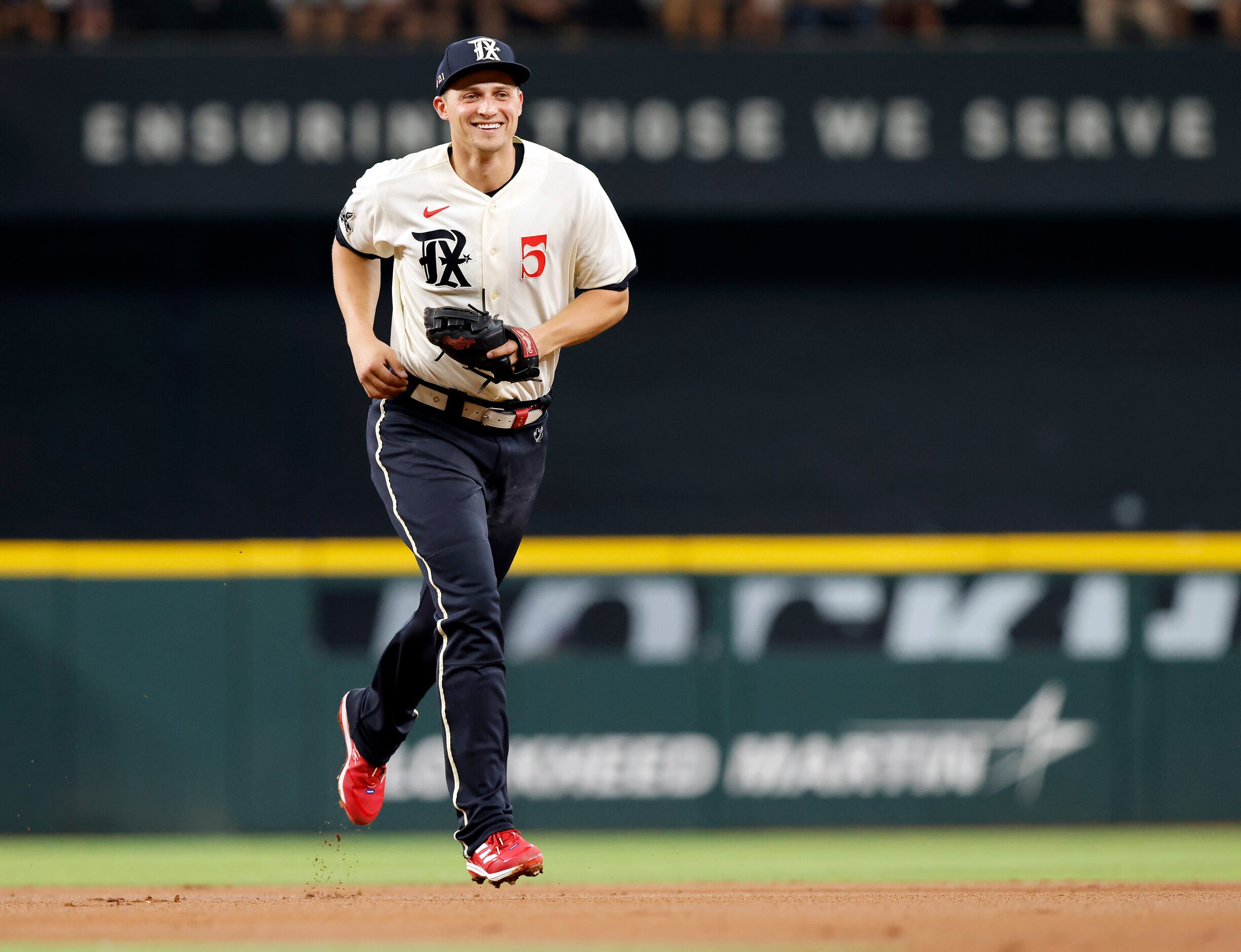 Texas Rangers shortstop Corey Seager (5) laughs after realizing he could have stepped on the...