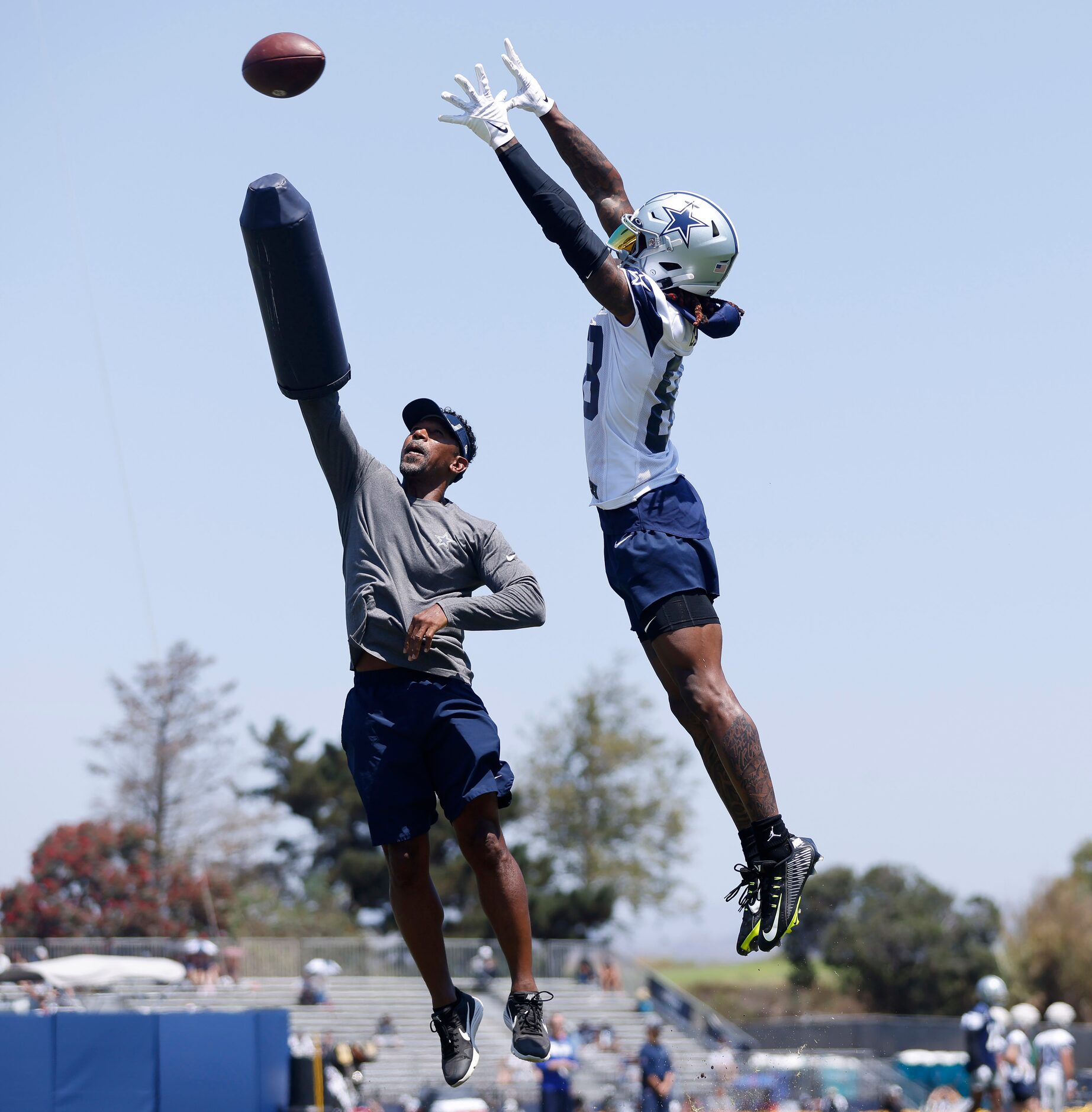 Dallas Cowboys wide receiver CeeDee Lamb (88)  skies high over wide receivers coach Robert...