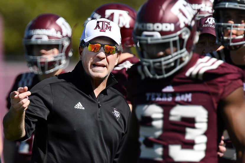 Texas A&M coach Jimbo Fisher talks to players during the first day of spring practice for...