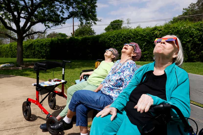 From left, Judy Green, Elizabeth Hobbs and Patricia Head look up as they enjoy the view of...