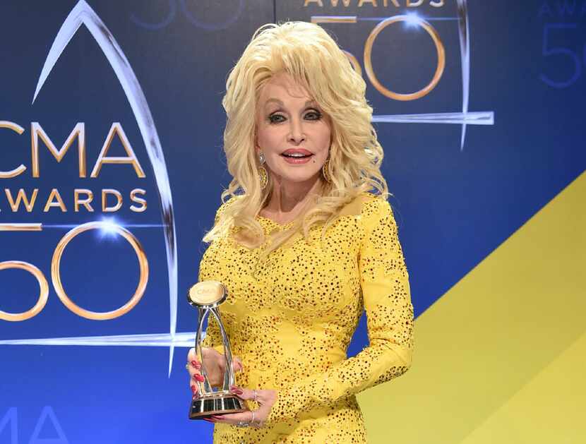 In this Nov. 2, 2016 file photo, Dolly Parton poses in the press room with the Willie Nelson...