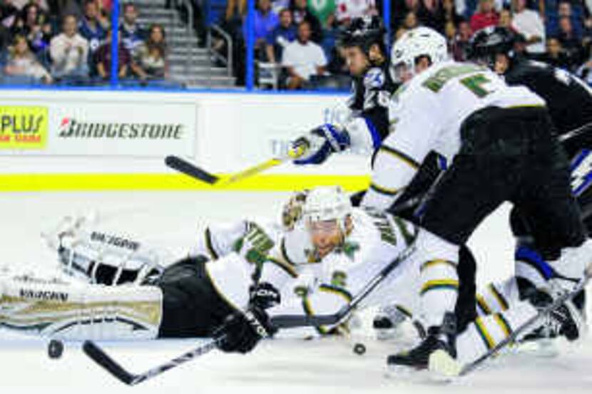  Stars defenseman Trevor Daley dives across the crease in an attempt to stop a second-period...