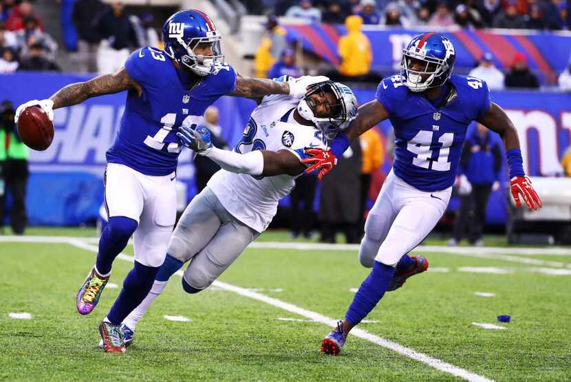 EAST RUTHERFORD, NJ - DECEMBER 18:  Odell Beckham #13 of the New York Giants returns a punt...