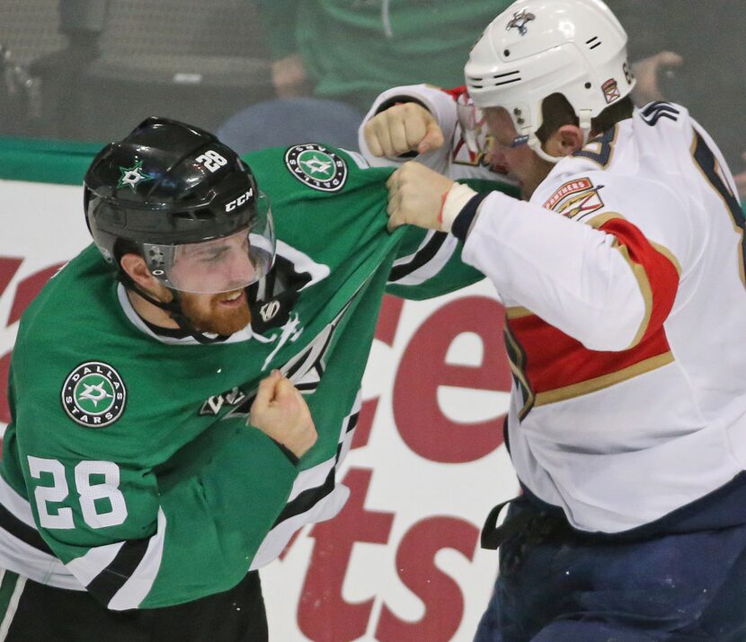 Dallas Stars defenseman Stephen Johns (28) and Florida Panthers left wing Jamie McGinn (88)...