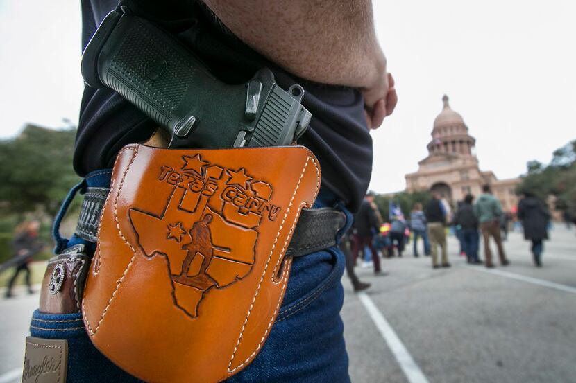  Terry Holcomb, executive director of Texas Carry, happily displayed his customized holster...