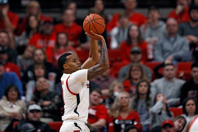 Texas Tech's Kyler Edwards (0) shoots for three points during the second half of an NCAA...