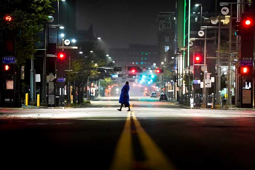 A solitary figure crossed the empty intersection of Main and Field streets in downtown...