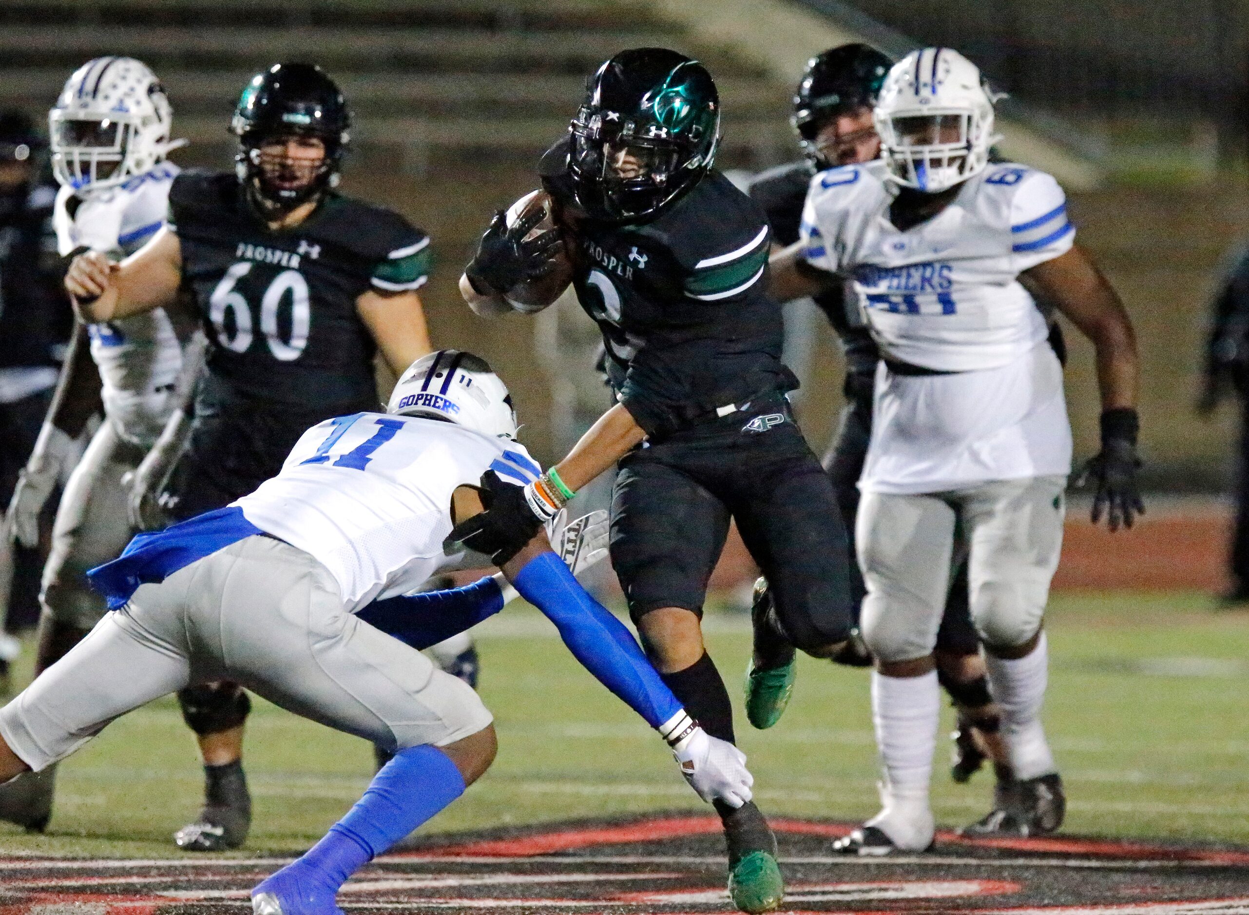 Prosper High School running back Malik Dailey (3) sidesteps Grand Prairie High School...