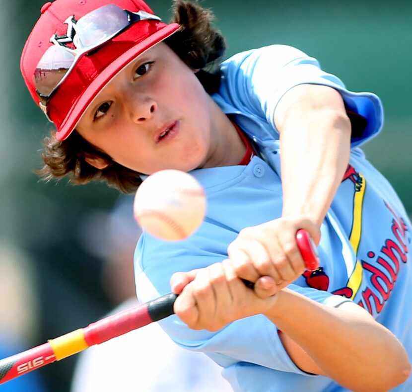 
Parker Rodriquez, 11, connects for his third home run during the home run derby for...