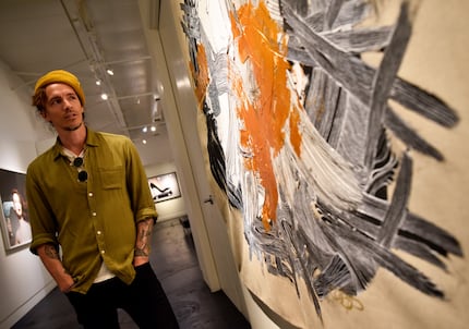 Brandon Boyd gazes at his piece titled Spiderling, mixed media on canvas, at Samuel Lynne...