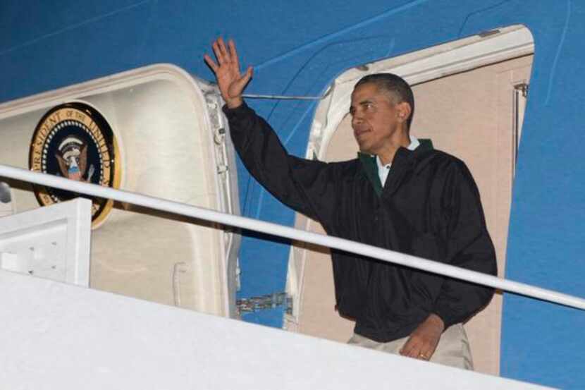 
President Barack Obama waves as he deplanes from Air Force One. 
