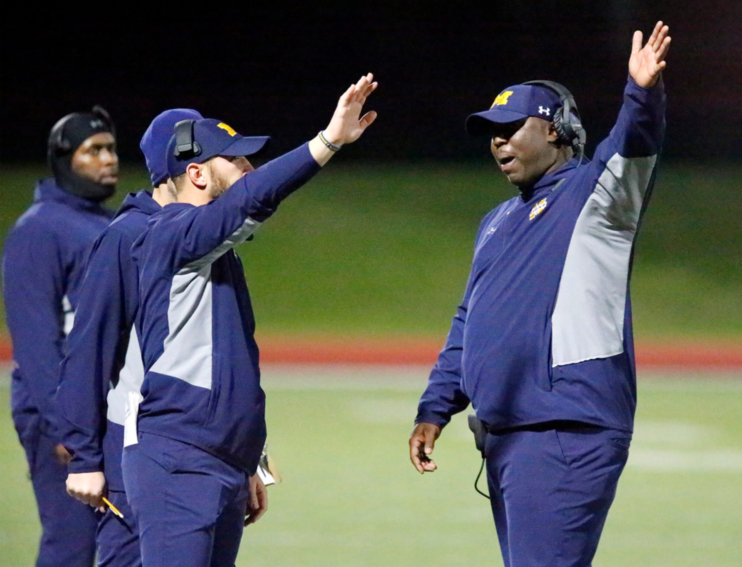 McKinney High School head coach Jeff Smith (right) talks to his coaches after a Wylie...