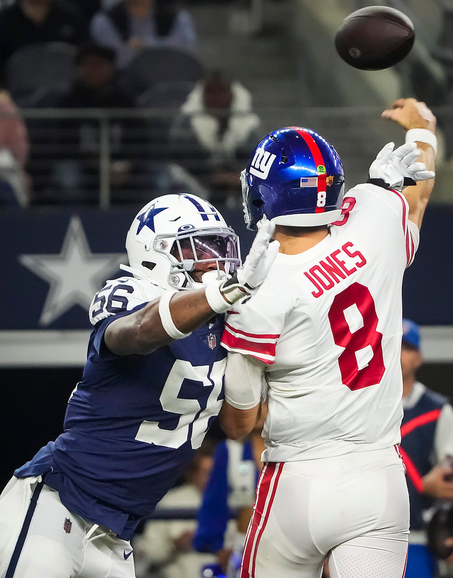 New York Giants quarterback Daniel Jones (8) throws a pass as he is hit by Dallas Cowboys...