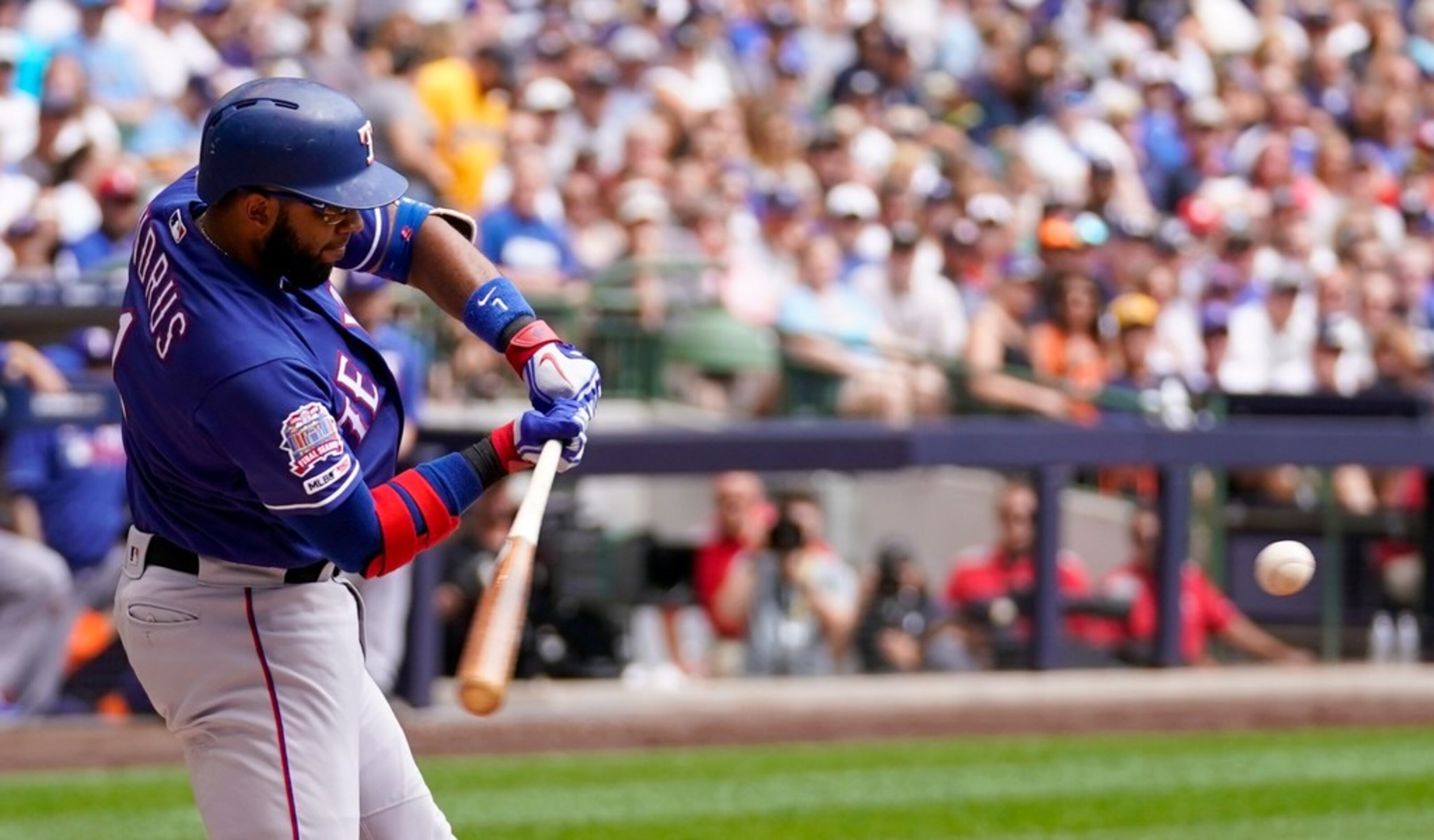 Texas Rangers' Elvis Andrus his a single during the first inning of a baseball game against...