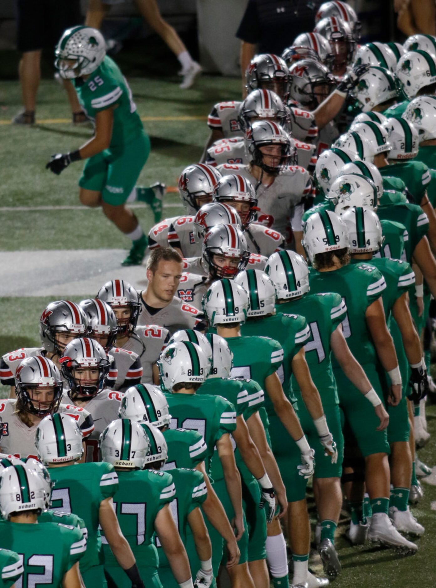 Flower Mound Marcus players greet their opponents from Southlake Carroll at midfield...