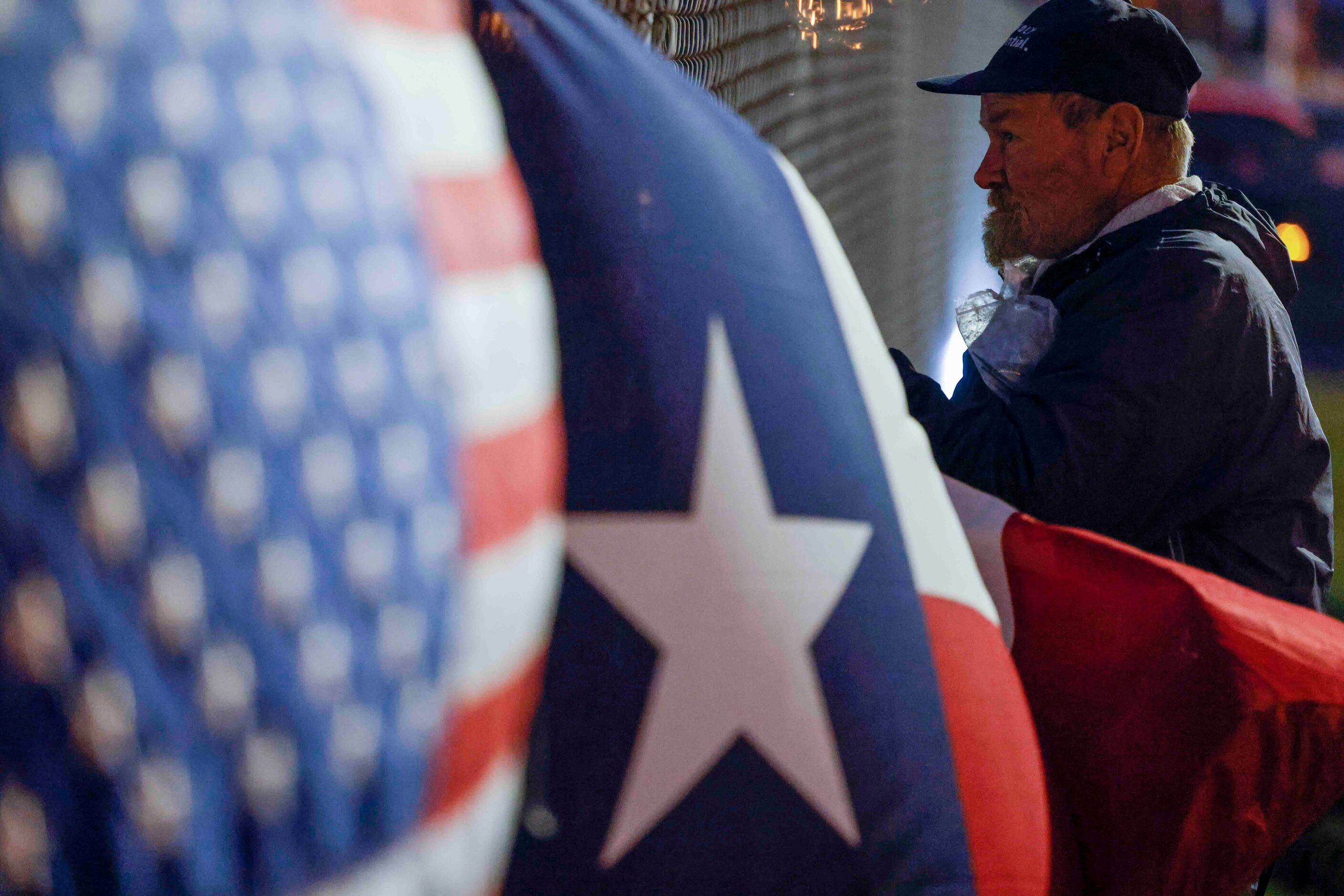 David Coleman, 59, looks through the fence line of the Dallas Executive Airport, Monday,...