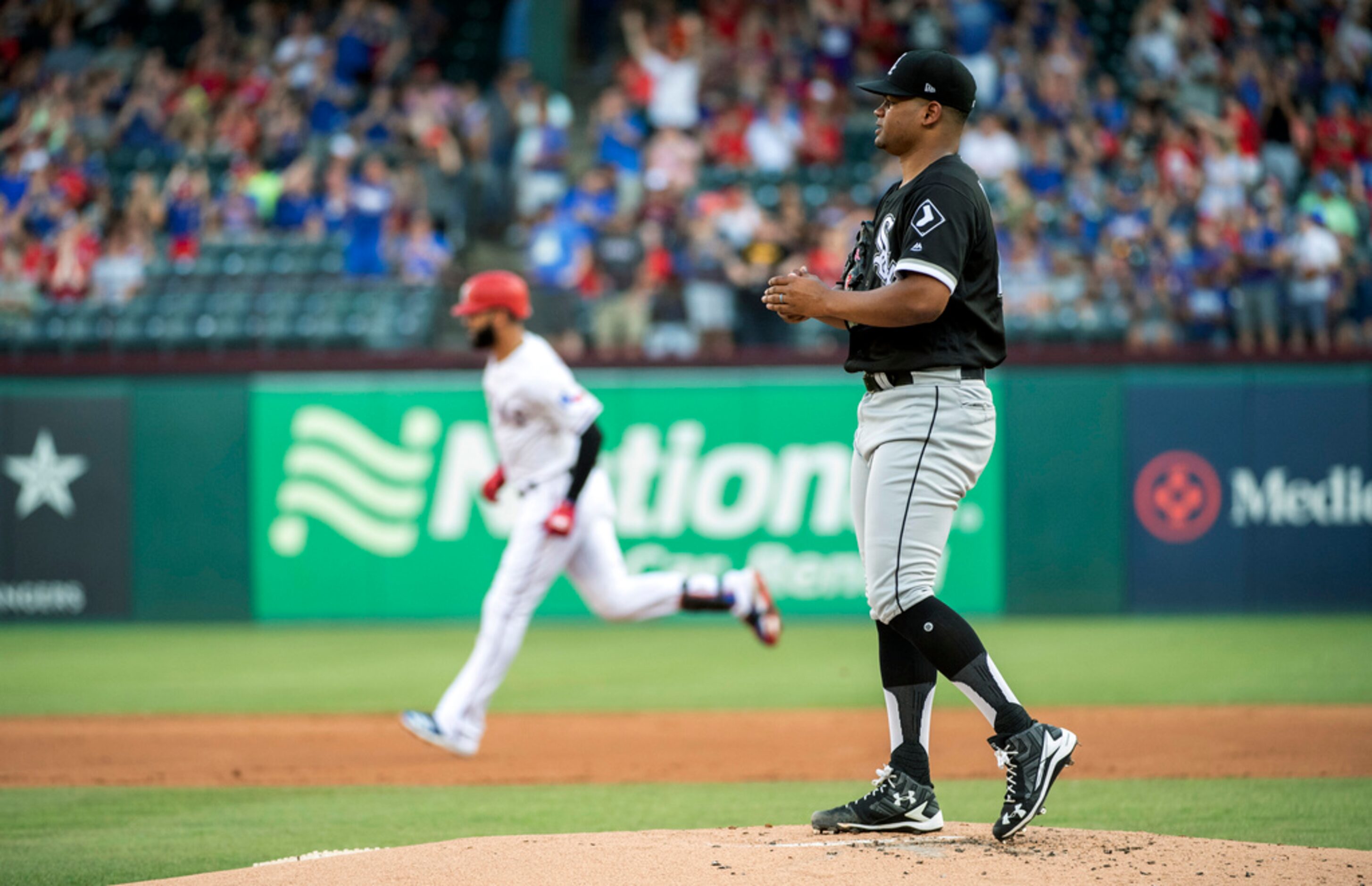 Chicago White Sox starting pitcher Reynaldo Lopez walks on the mound after giving up a...