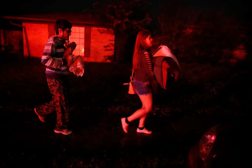 Karime Coronado and her brother (did not want to give name) evacuate their home on Nogales...