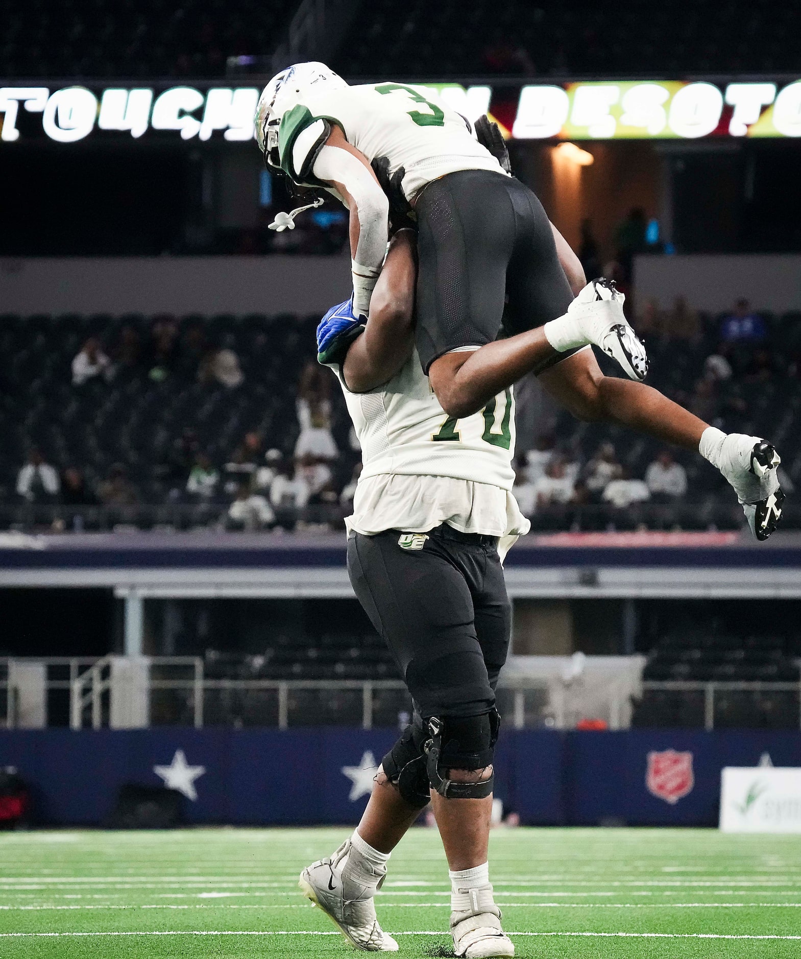 DeSoto linebacker Brandon Booker (3) celebrates with Dylan Johnson (70) after returning a...