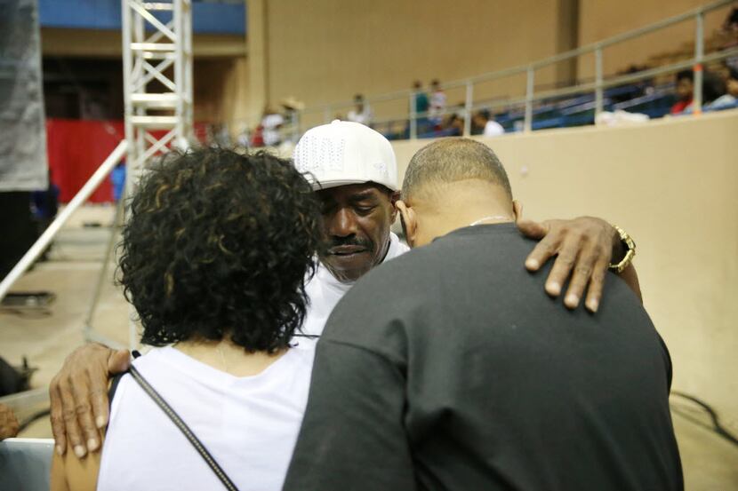 Kurtis Blow (center) prays with Shari Catching (left) and William Catching, of Little Elm,...