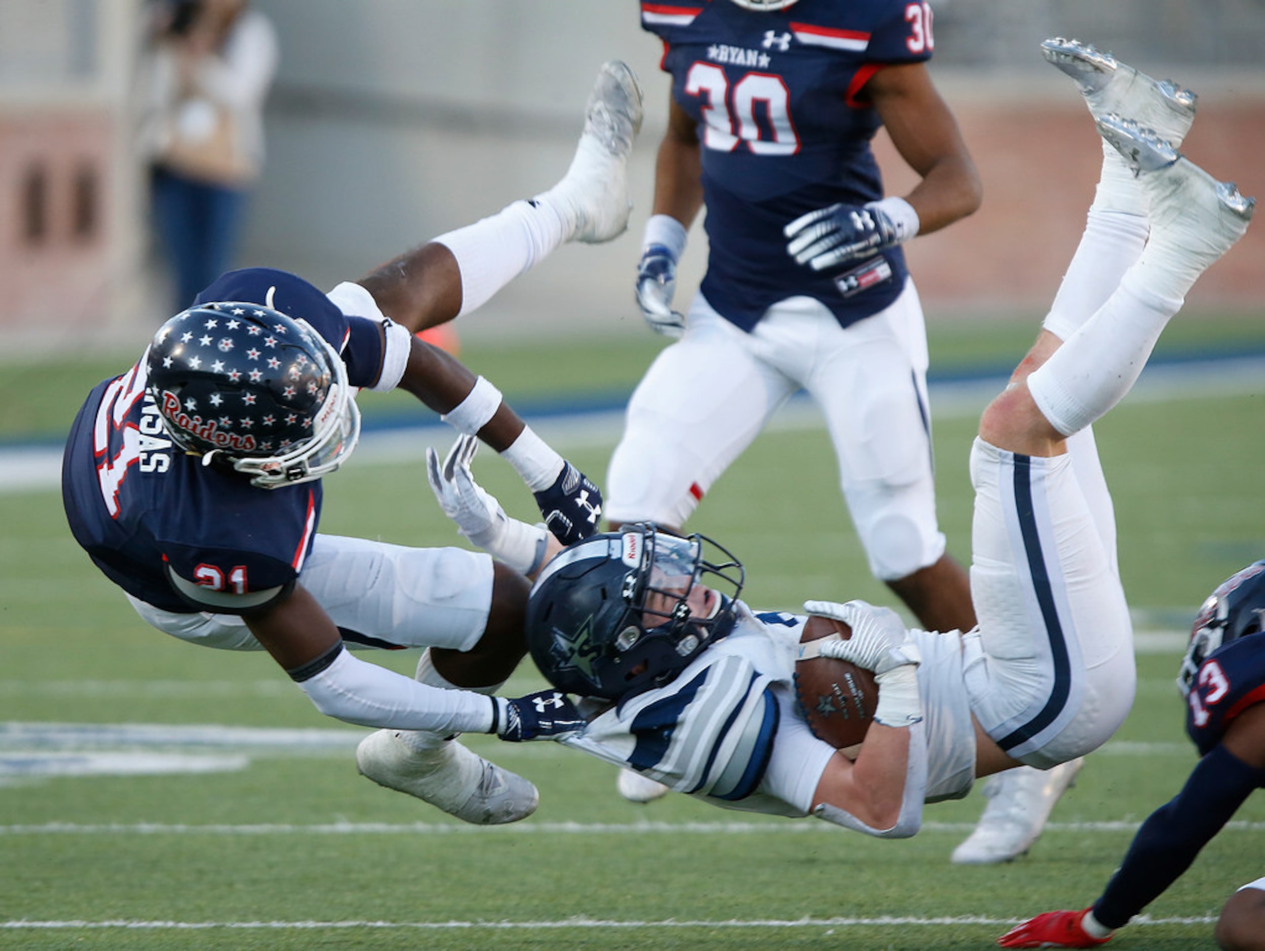 Lone Star High School running back Jake Bogdon (2)is brought down by Denton Ryan High School...