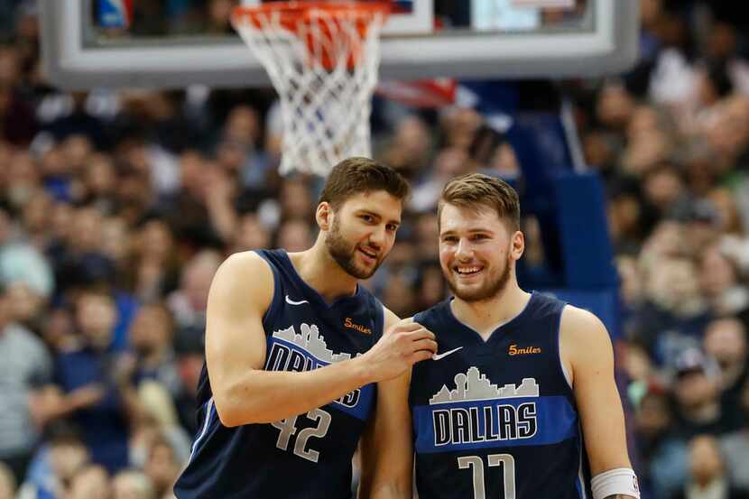 Dallas Mavericks forward Luka Doncic (77) and forward Maximilian Kleber (42) share a laugh...