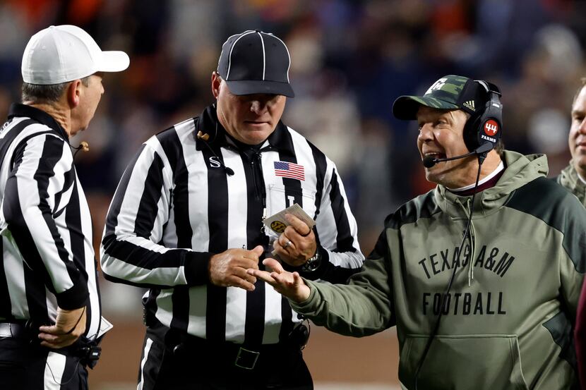 Texas A&M head coach Jimbo Fisher talks with referee David Smith during the first half of an...