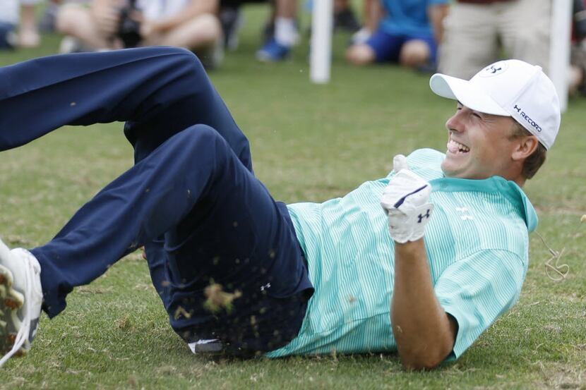 Jordan Spieth celebrates after catching a marshmallow in his mouth after hitting a golf ball...