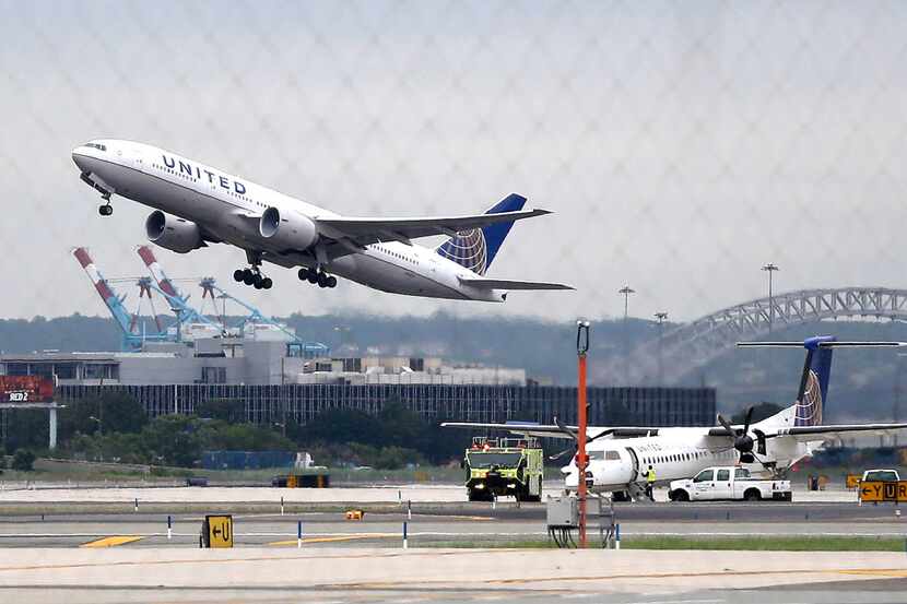 FILE - In this July 25, 2013, file photo, a United Airlines plane takes off from Newark...