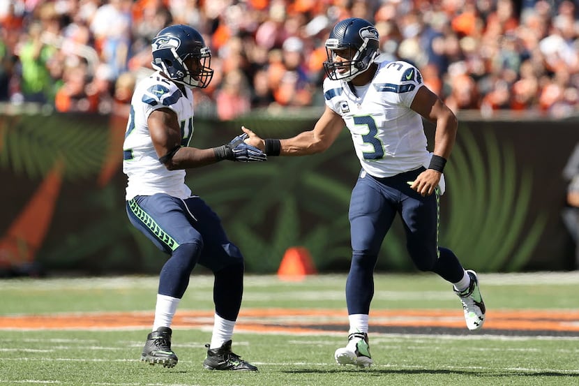 CINCINNATI, OH - OCTOBER 11:  Russell Wilson #3 of the Seattle Seahawks is congratulated by...