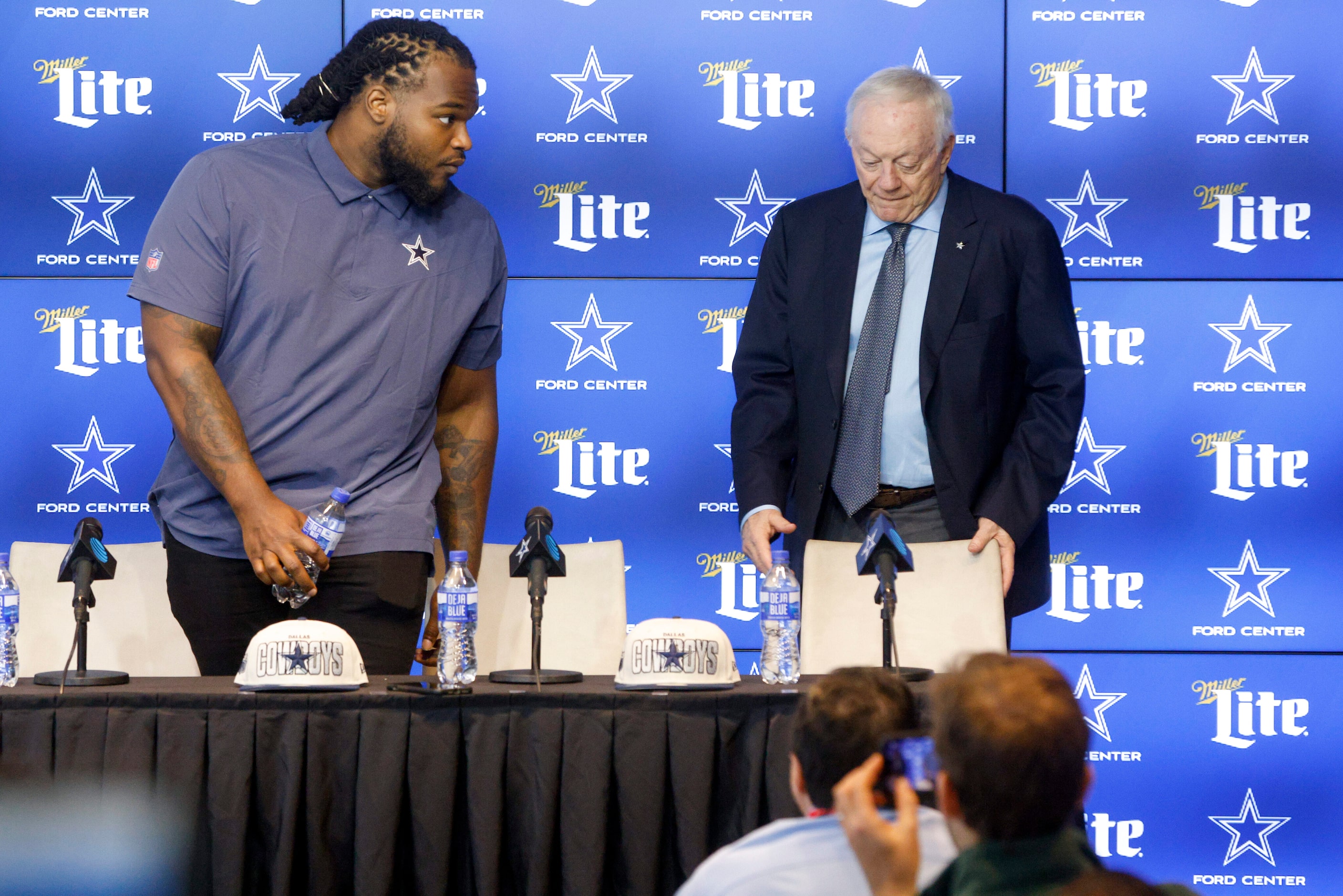 Dallas Cowboys rookie defensive tackle Mazi Smith takes a seat next to owner Jerry Jones...