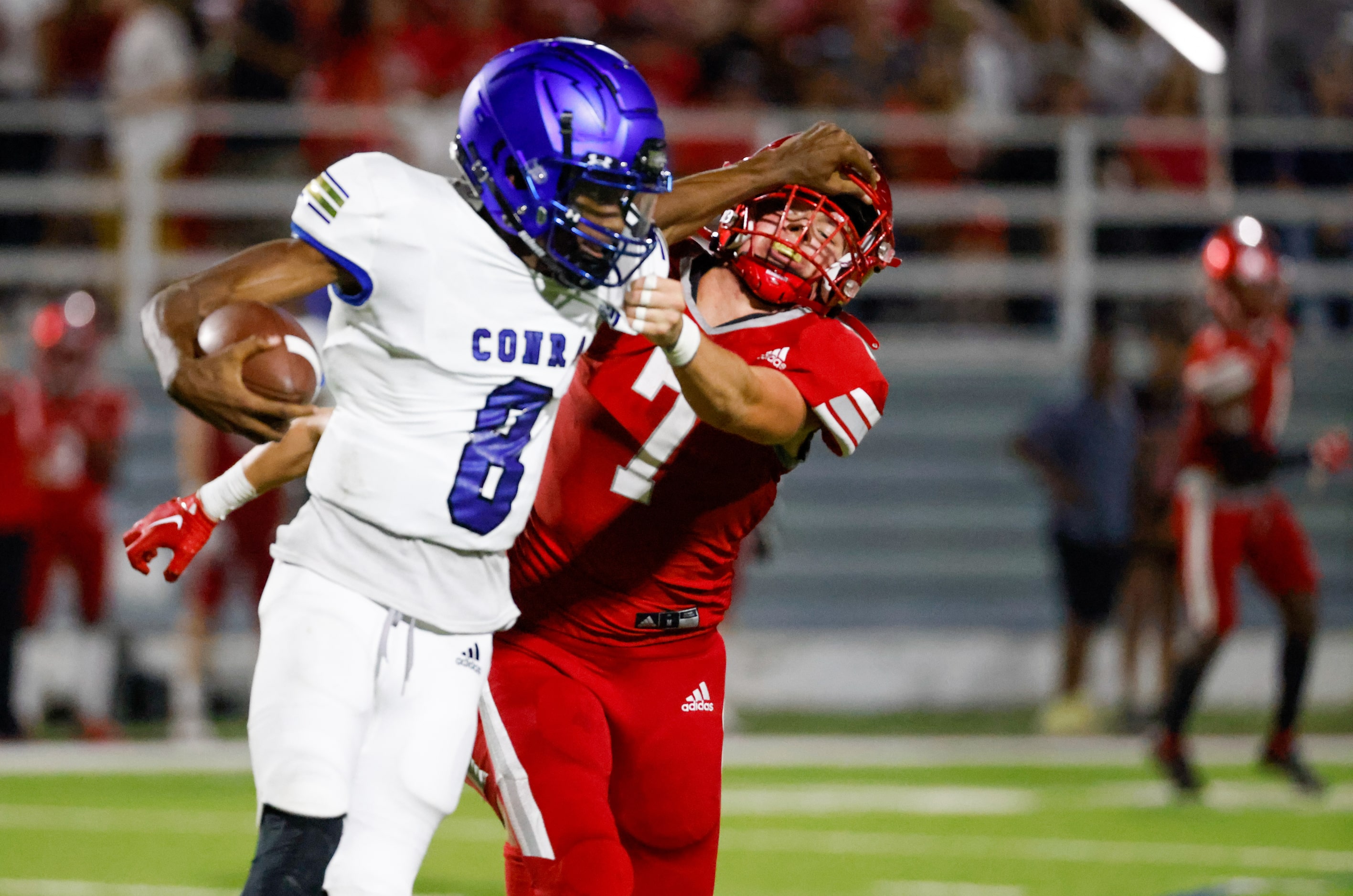 Conrad quarterback Ladavian Frost-Harris (8) pushes against Woodrow Wilson line backer Jake...