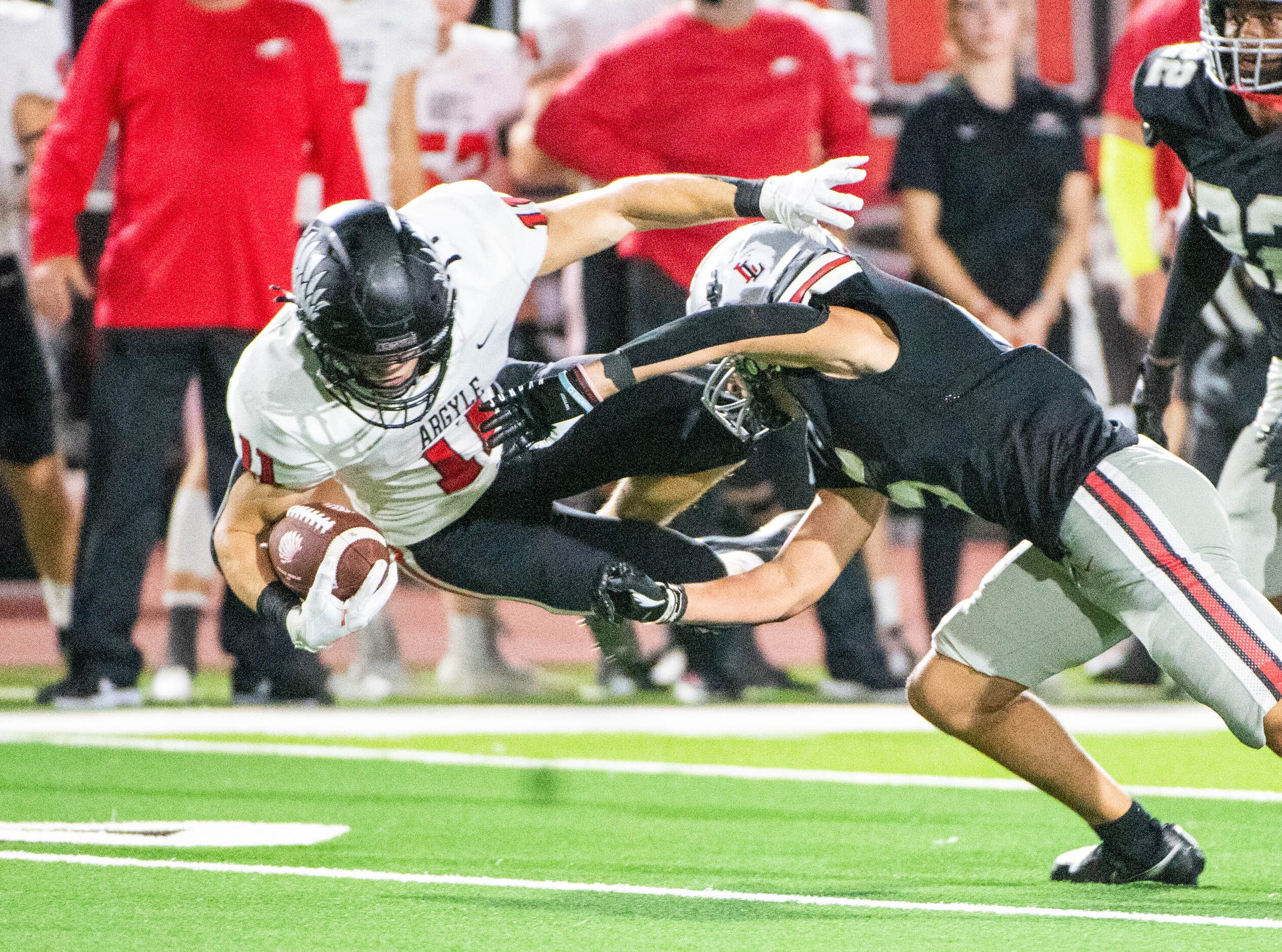 Argyle's RJ Bunnell (11) is tackled by Lovejoy's Avery Fuller (5) during a high school...