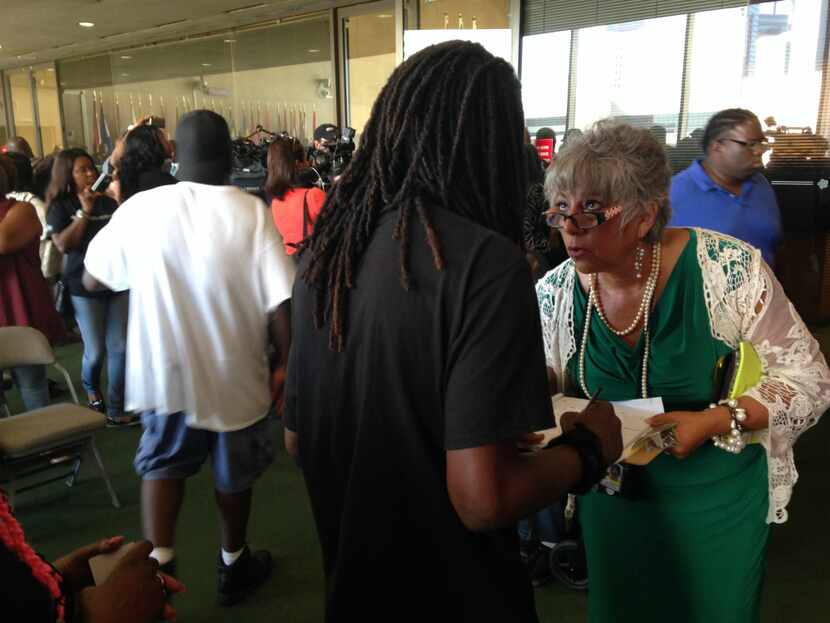 A homeless man meets with a city of Dallas caseworker outside the council chambers Wednesday.