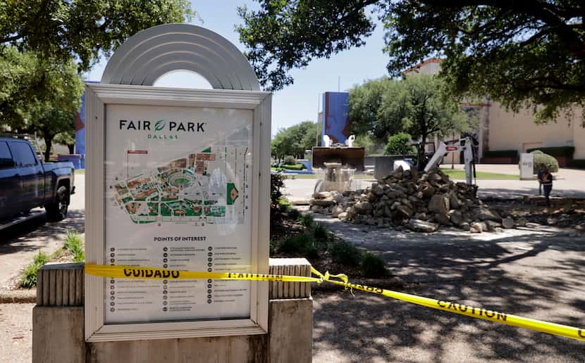 A construction crew replaces the sidewalk near the Main Entrance to Fair Park in Dallas, May...