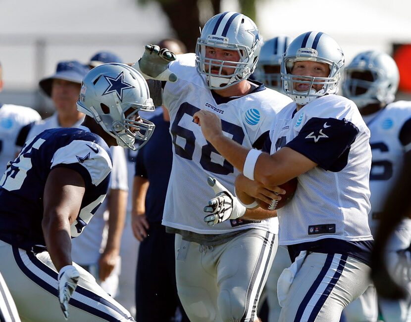 Dallas Cowboys quarterback Tony Romo (9) winces as he is about to be sacked by defensive...