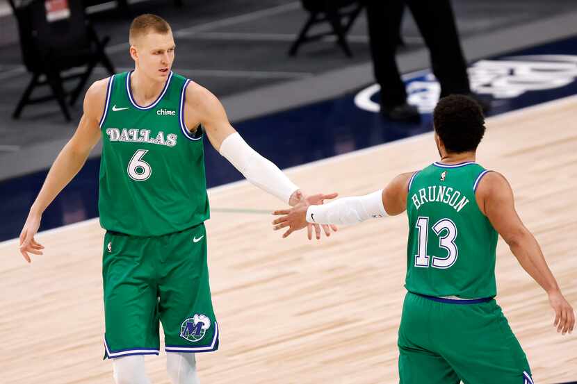 Dallas Mavericks center Kristaps Porzingis (6) is congratulated on one of his fourth quarter...