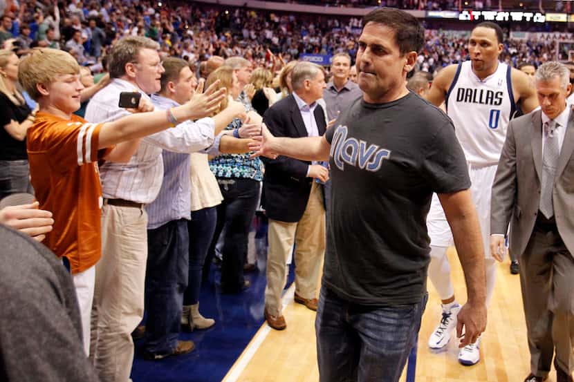 Dallas Mavericks owner Mark Cuban celebrates with fans after defeating the Denver Nuggets in...
