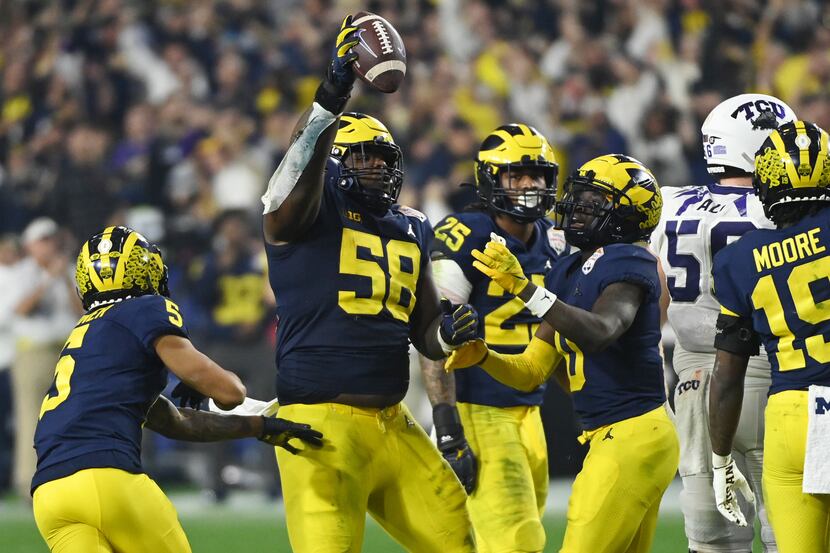 Mazi Smith #58 of the Michigan Wolverines celebrates after recovering a fumble during the...