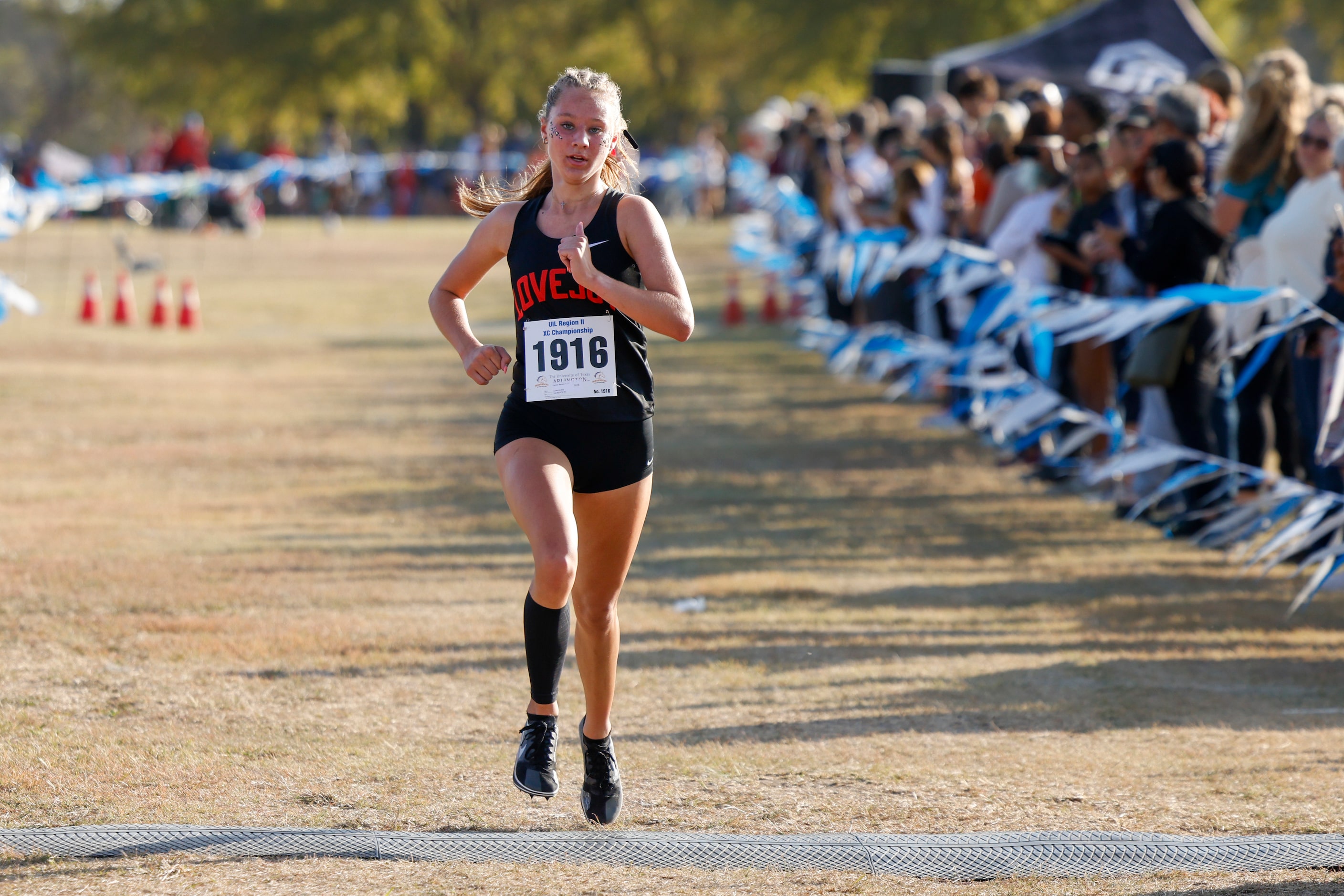 Lucas Lovejoy’s Camryn Benson crosses the finish line to win the girls UIL Class 5A Region...