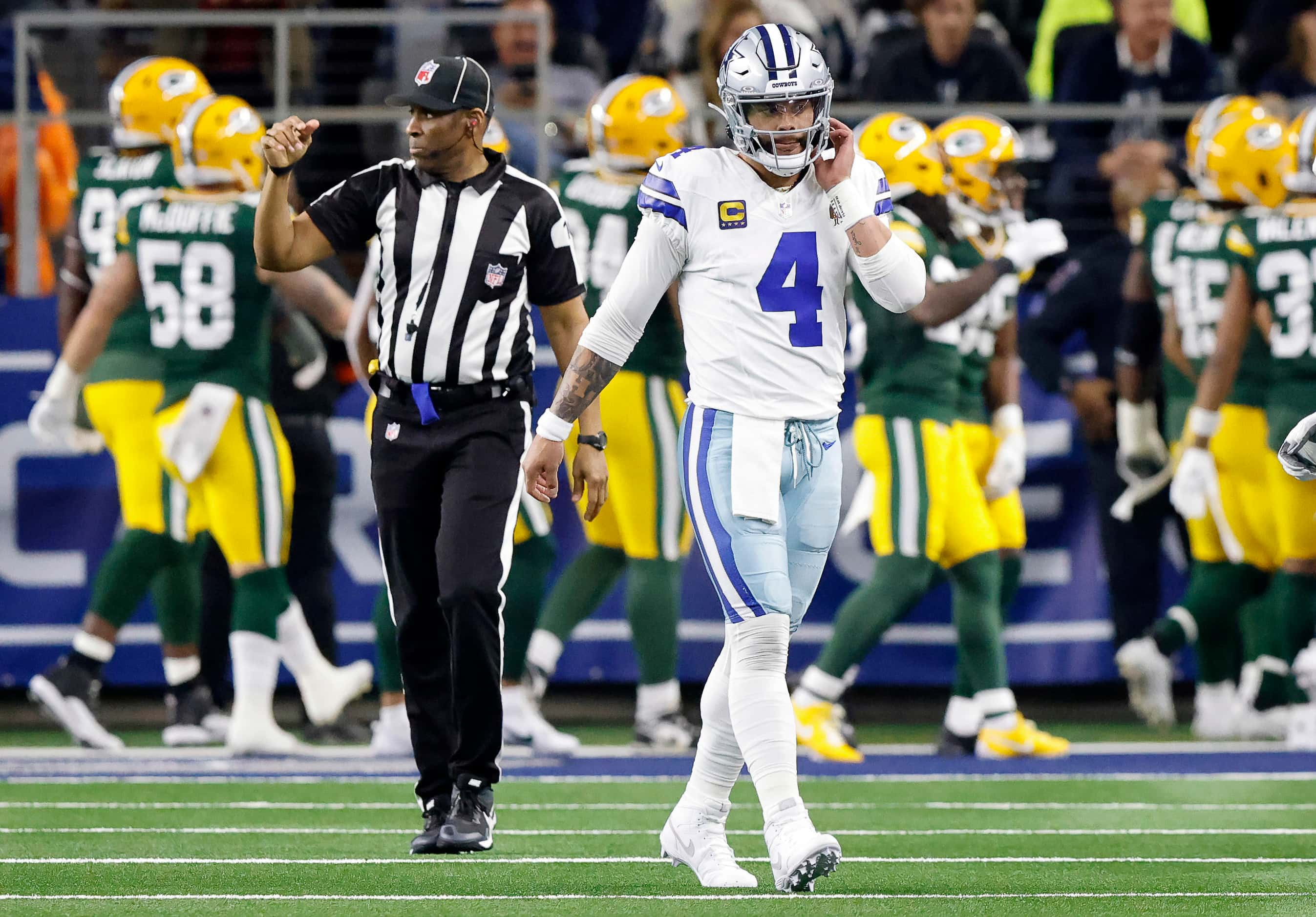 Dallas Cowboys quarterback Dak Prescott (4) walks to the sideline after throwing a first...