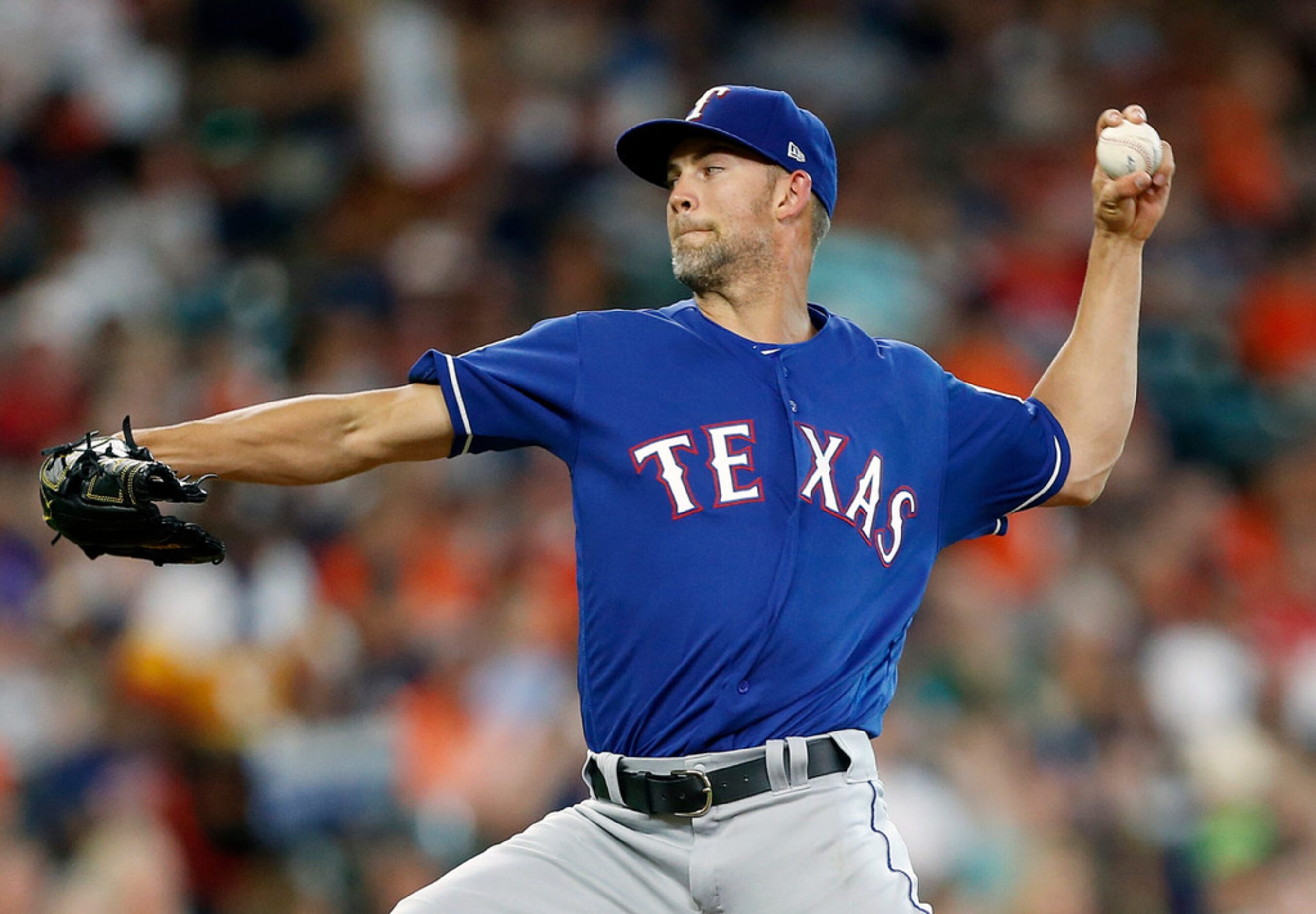 HOUSTON, TEXAS - JULY 19: Mike Minor #23 of the Texas Rangers pitches in the first inning...