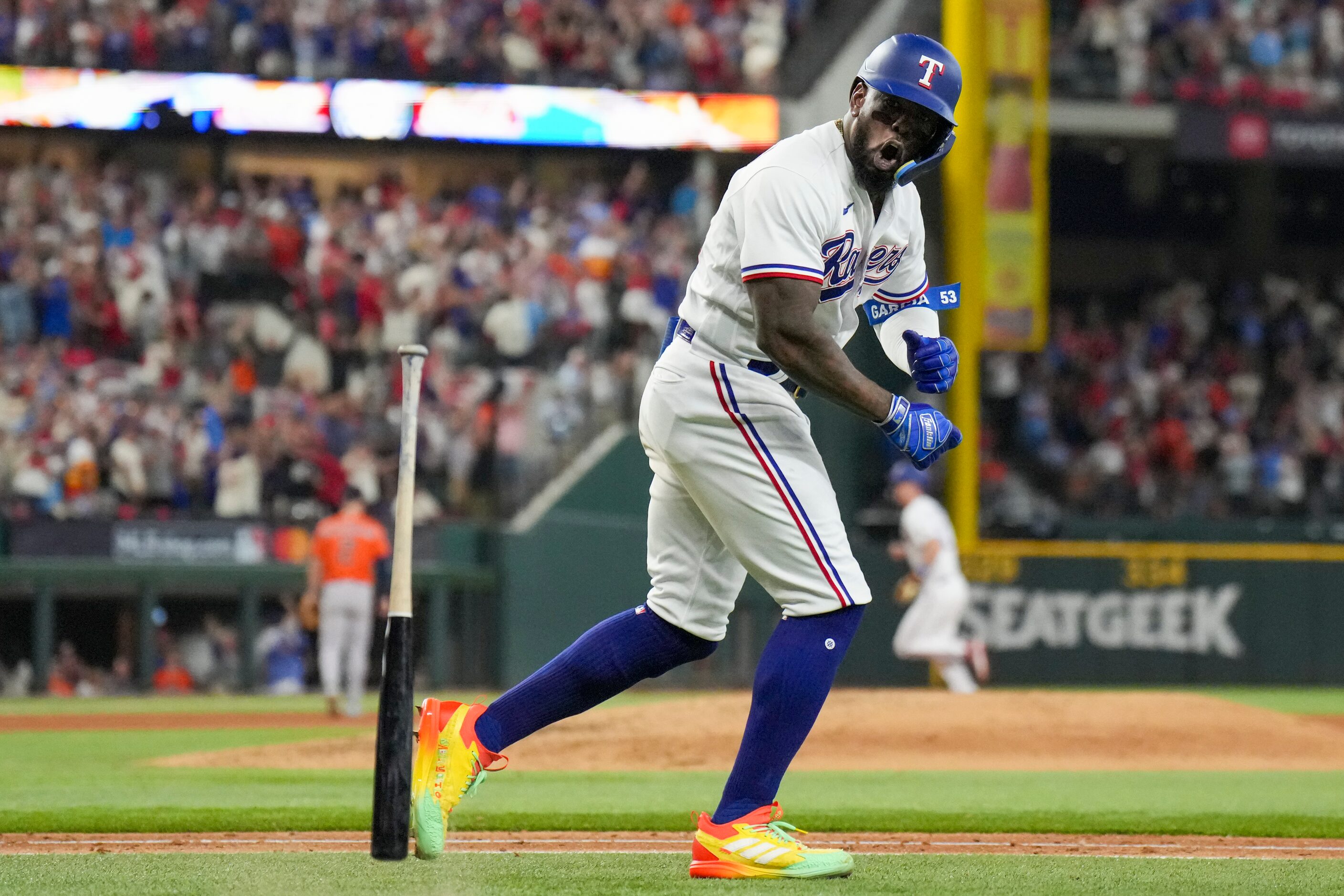 Texas Rangers right fielder Adolis Garcia (53) slams his bat to the ground after hitting a...